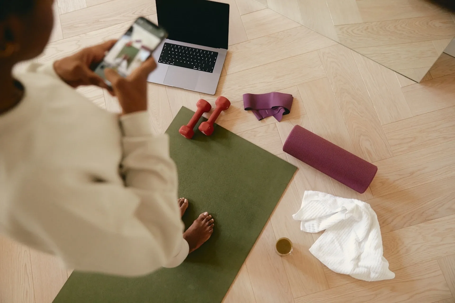 Person stood on a yoga mat and taking a photo
