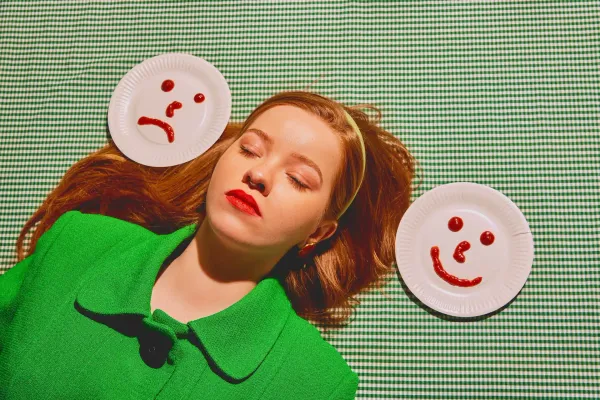 Woman laying down next to two plates